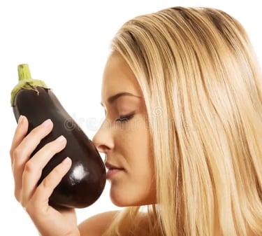 blonde, white woman smelling an eggplant