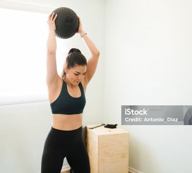 a young lady holding an exercise ball