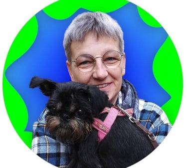 a woman in glasses and a plaid shirt is holding a dog