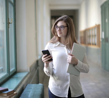 Confident mother holding a notebook in a school hallway, prepared for her child's IEP meeting