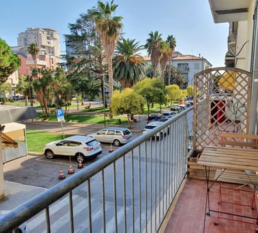 a balcony with a bench and a table with a chair