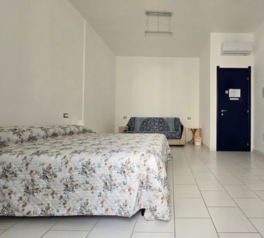 a bedroom with a bed and a television