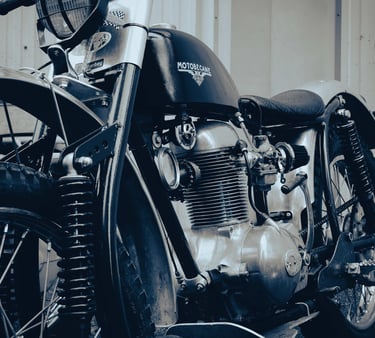 an old motorcycle parked in front of a building