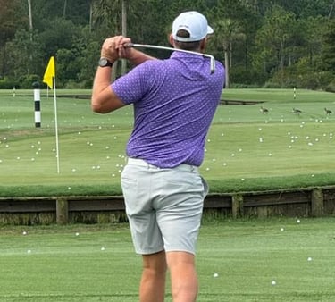Men’s performance golf polo in purple on golf course