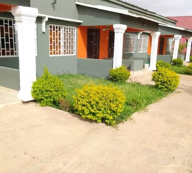 A charming view of the Kakuba Garden Hotel, featuring well-maintained guest rooms surrounded by lush