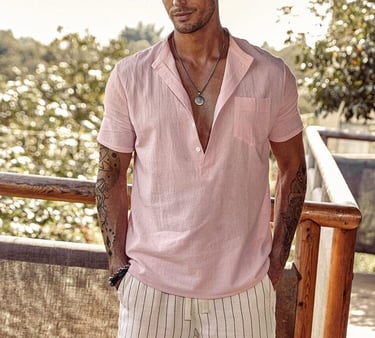 a man in a pink shirt and white shorts