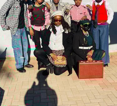 A group of stylish young people posing in vintage streetwear and retro fashion accessories outdoors.