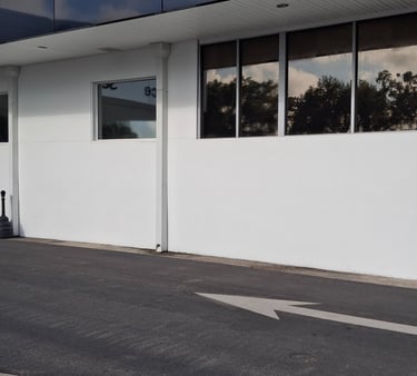 Fresh white paint on dealership's service drive.