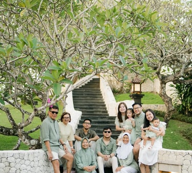 Three generation family posing together in a tropical garden during a family photography session in Bali.