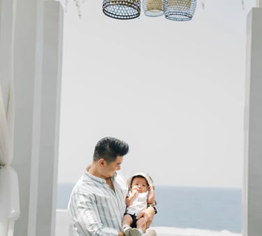 Father holding his baby during a family photography session at Samabe Bali Suites & Villas in Nusa Dua.