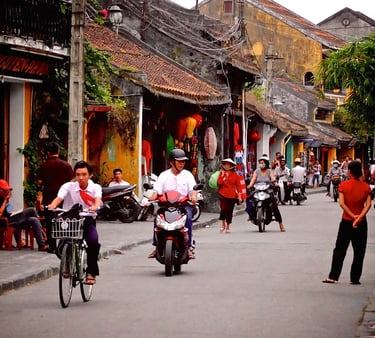 a group of people riding bikes down a street