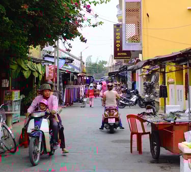 a man and woman riding on a motorbike