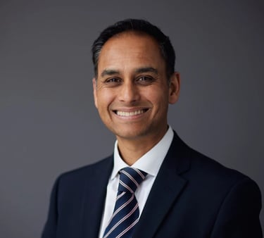 a man in a suit and tie smiling