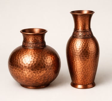 Hand hammered copper vases with textured surface and polished antique finish.
