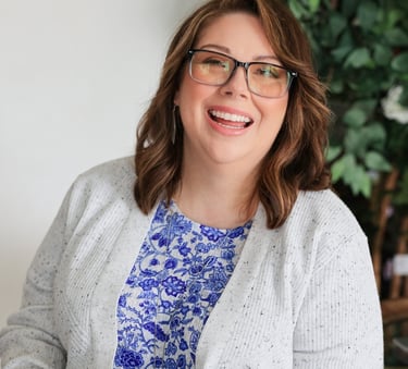 a woman in glasses and a blue top