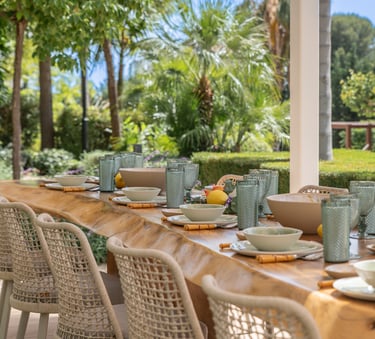 Spacious wooden dining table in the outdoor dining area of Villa Serenity