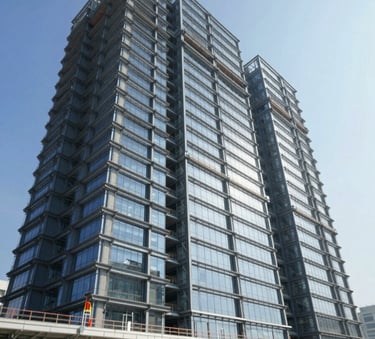 A low-angle shot of a massive government infrastructure project, possibly a new civic center, featuring sharp architectural lines, steel beams, and glass panels. The lighting is bright and authoritative, with a clear blue sky. Incorporates colors #2C3E50 and #5C7D99 in the materials.