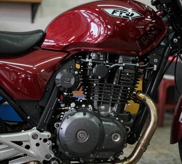 A cinematic close-up of a clean motorcycle engine block in a South American / Brazilian repair shop, professional lighting, emphasizing mechanical precision and quality, colors include deep red and near black.