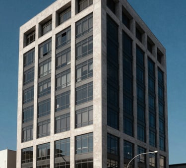 Architectural photography of a modern commercial building facade in a South American urban center, featuring clean geometric lines of glass and concrete under a clear Prussian Blue sky.