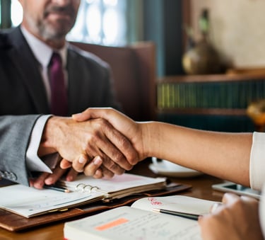 a man and woman shaking hands in a meeting