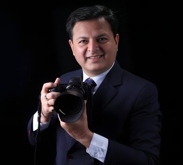 a man in a suit and tie is holding a camera