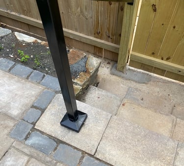 a metal pole with a black metal frame