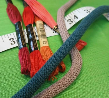 a bunch of thread - wrapped thread threads and scissors
