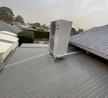 Fujitsu 20kW ducted reverse cycle air conditioning outdoor unit on roof bracket
