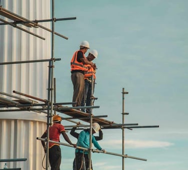 a group of men standing on scaffolding scaffolding
