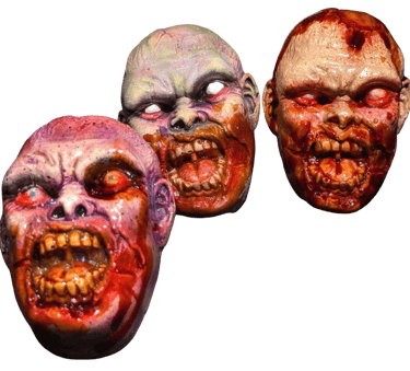 a group of three different colored zombie magnets 