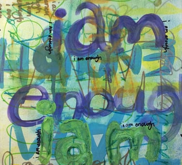 A layered declaration of worth: “I am enough” painted in varying colors, sizes, and tones.