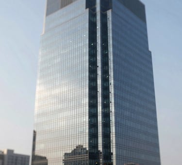 A sophisticated, high-angle shot of a modern glass skyscraper reflecting a clear sky, incorporating a palette of #0D1B2A and #778DA9. The lighting is crisp and professional, symbolizing forward-thinking corporate ambition.