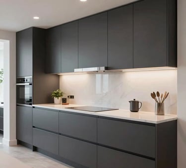 A high-end interior renovation in a Northern European / British home, showing a modern open-plan kitchen with clean lines, sophisticated charcoal cabinets, and bright lighting.