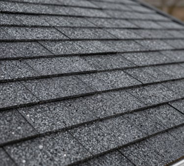 Close-up photography of high-quality architectural shingles in charcoal grey, showing texture and precision installation on a North American home, soft natural light.