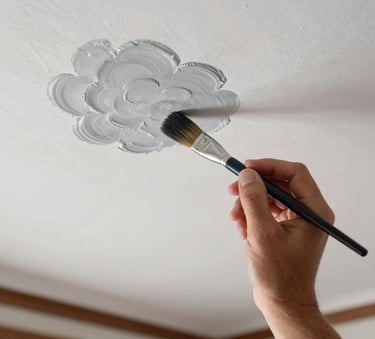 Macro photography of a professional painter's hand using a precision brush to create a sharp edge with clouds grey paint on a white ceiling in a Turkish / Anatolian home interior. Meticulous and clean workmanship.