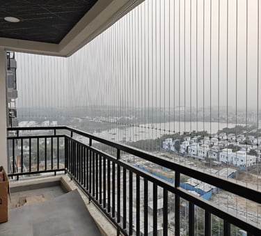 A close-up of a high-tensile stainless steel invisible grill installed on a luxury Hyderabad apartme