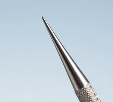 Macro photography showing the detailed texture and precision tip of a stainless steel dental surgical scaler. The background is a minimalist sky blue gradient. Clean, professional composition for a North American medical supplier.