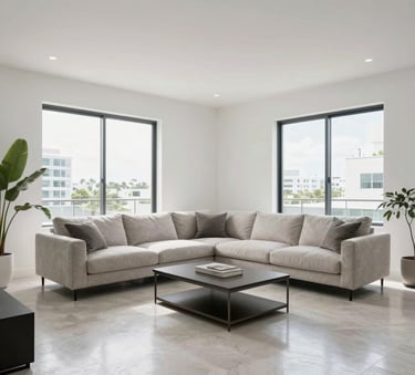 A professionally restored modern living room in a Miami home with clean white walls and polished floors, bright natural light coming through large windows, high-quality architectural photography style.