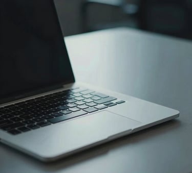 A close-up of a sleek laptop on a minimalist desk in a North American office, with muted teal and steel blue tones in the lighting, professional and focused atmosphere.