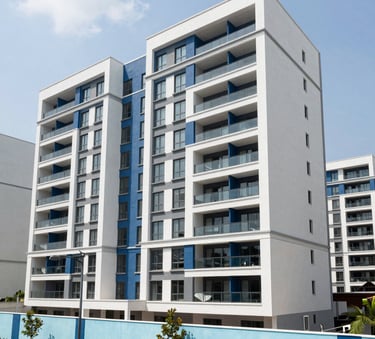 Wide-angle photograph of a modern residential development in Abidjan, showcasing clean lines and contemporary architecture under a bright sky, with accents of medium blue and light blue in the landscape design.