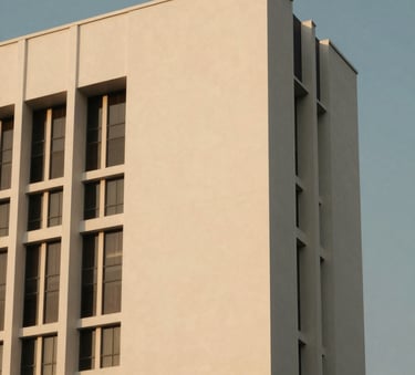 Architectural close-up of a modern Indonesian government building with minimalist clean lines, reflecting a soft gold light against a muted blue sky.