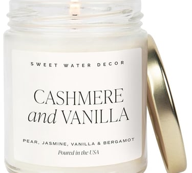 Sweet Water Decor Cashmere and Vanilla scented glass jar candle with a gold lid.