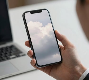 A professional person in a North American business setting holding a sleek smartphone, the screen reflecting soft cloud white and mist grey light, professional lighting.