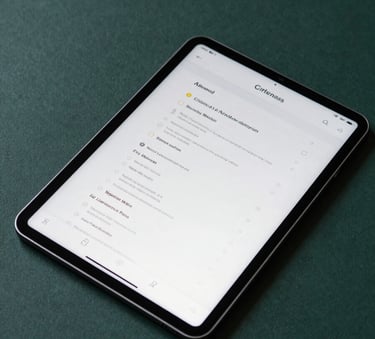 An overhead shot of a sleek tablet displaying a clean user interface, resting on a Deep Sea Green surface with soft ambient lighting.