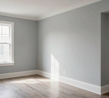 A spacious and bright home interior in Venice, Florida. The walls are newly painted in a contemporary soft gray with clean white trim, reflecting high-quality craftsmanship under bright natural light.
