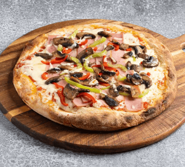 Freshly baked homemade pizza with mushrooms, ham, and peppers on a wooden serving board.