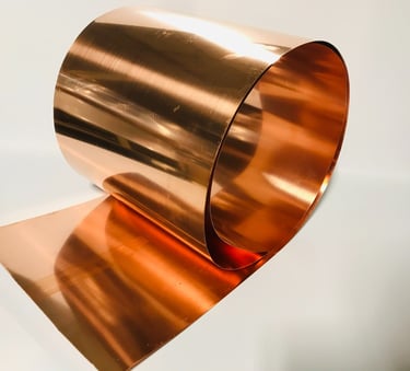 a copper plated metal object with a wine bottle