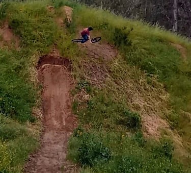 Rider turning mid-air on a hip jump, angling sideways