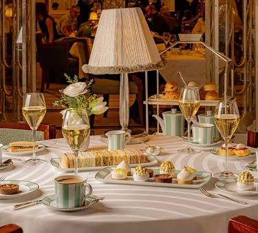 Elegant afternoon tea at Claridge’s with pastries and champagne.