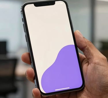 A close-up photograph of a premium smartphone held by a professional in a modern South Asian Indian office. The phone's screen is glowing with a clean, minimalist interface using off-white and purple tones, reflecting a sophisticated fintech aesthetic.